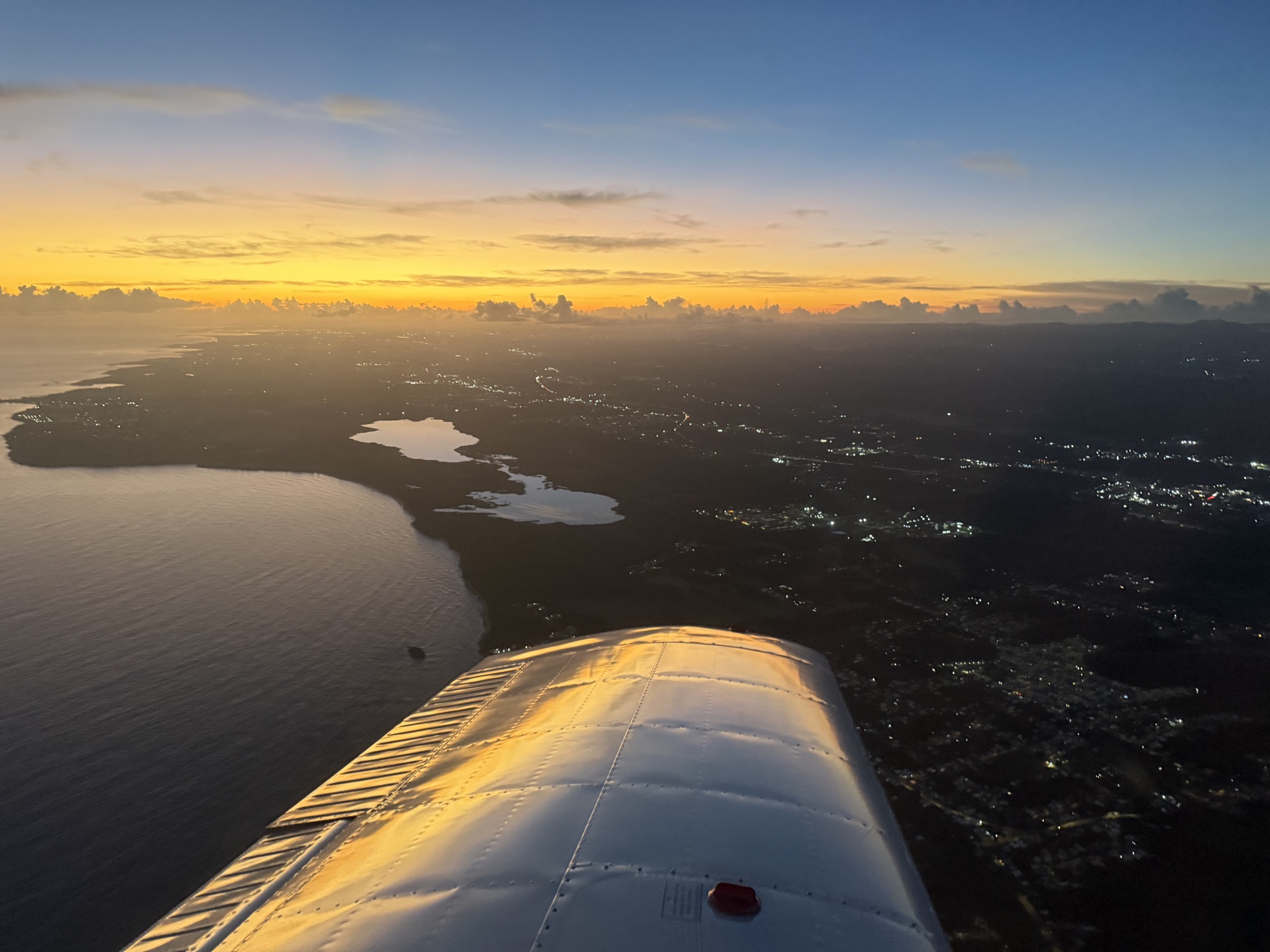 Sunset over the Puerto Rico coastline from the cockpit